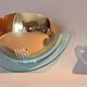 Pair of gold metal and plexiglass wall lights, circa 1980.