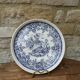 Old ceramic plate with scene of life and blue floral decor Van Melle