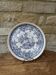 Old ceramic plate with scene of life and blue floral decor Van Melle