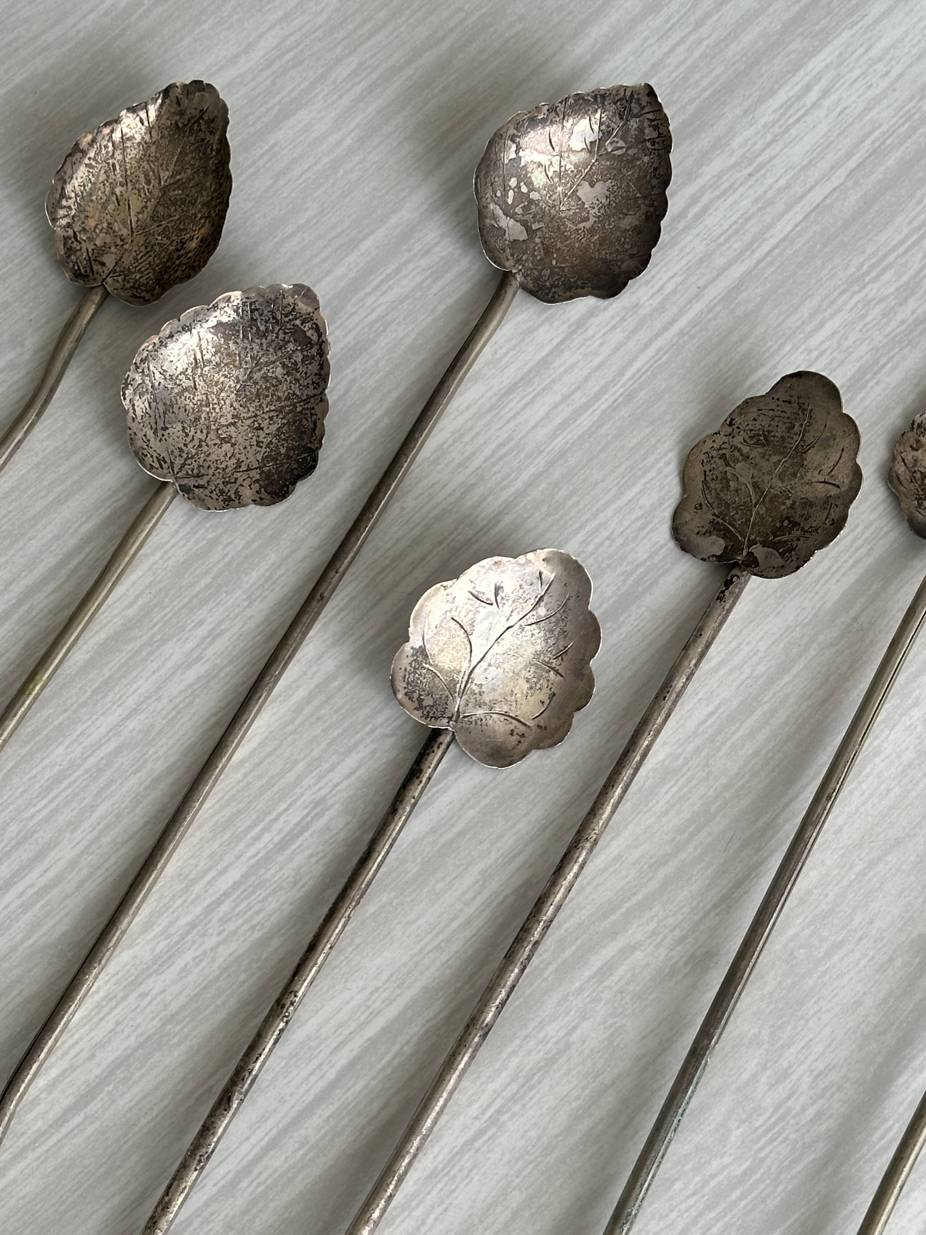 Vintage spoon in old metal, leaf pattern