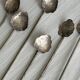 Vintage spoon in old metal, leaf pattern
