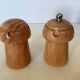 Salt and pepper shakers in wood shaped like a champagne cork.