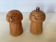 Salt and pepper shakers in wood shaped like a champagne cork.