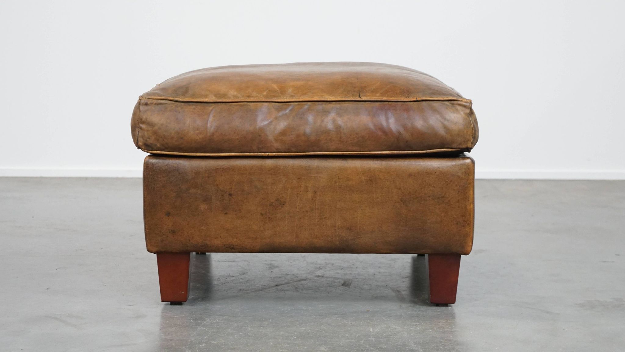Sheepskin wing chair + XXL patinated footrest