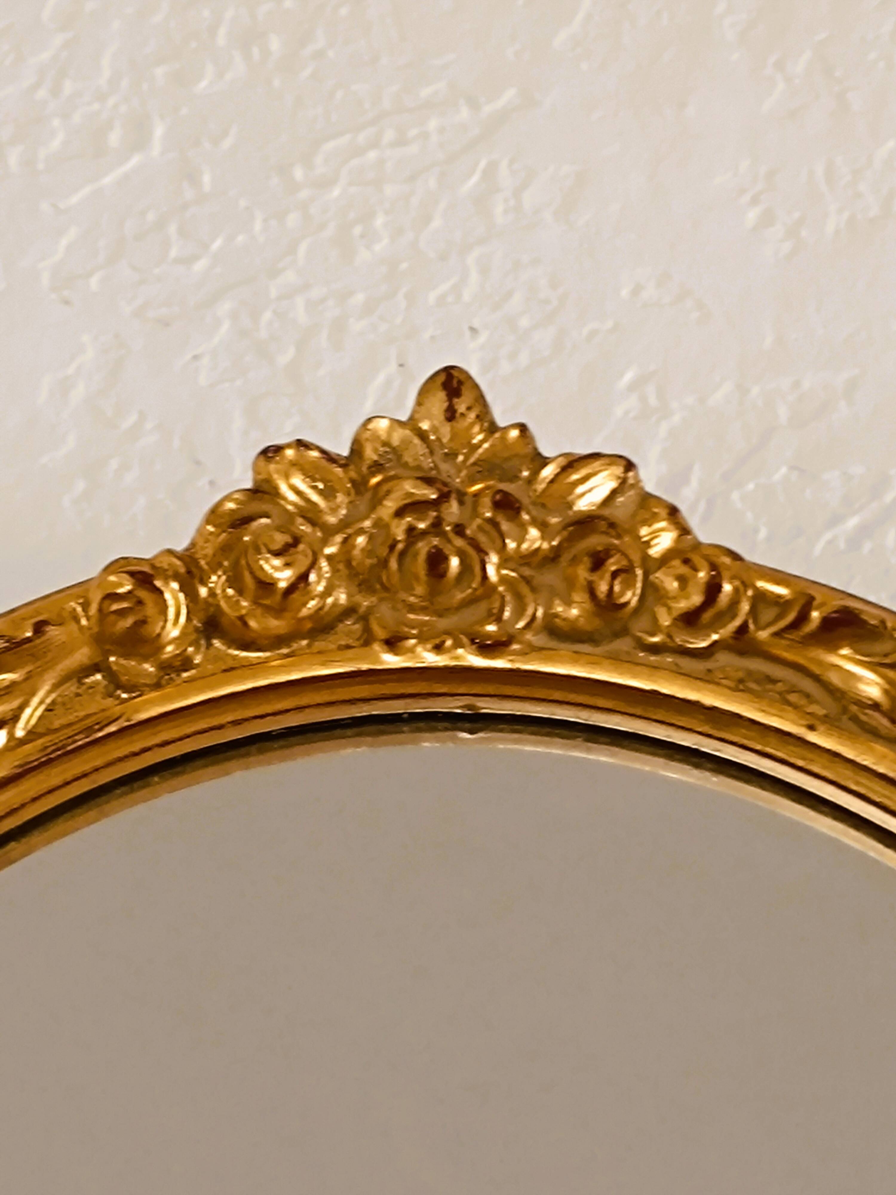 Antique oval-shaped gilded mirror