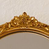 Antique oval-shaped gilded mirror