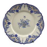 Old earthenware dish with a floral basket decoration.