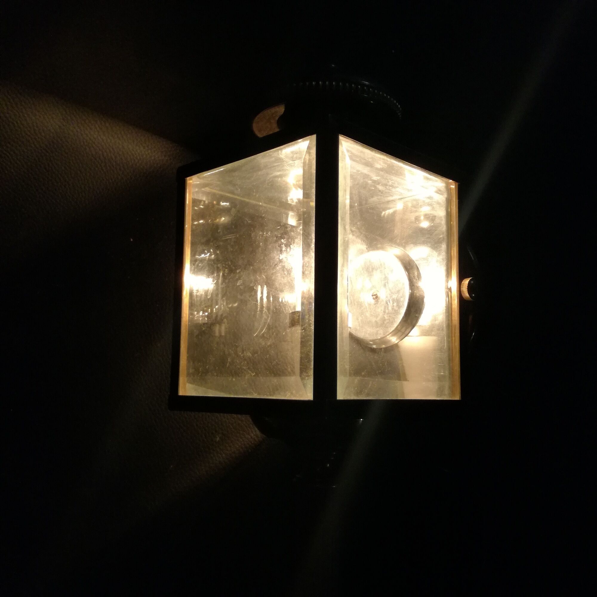 Brass and beveled glass lantern-like wall lamps in brass and beveled glass