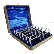 12 silver-plated metal knife handles, in a case.