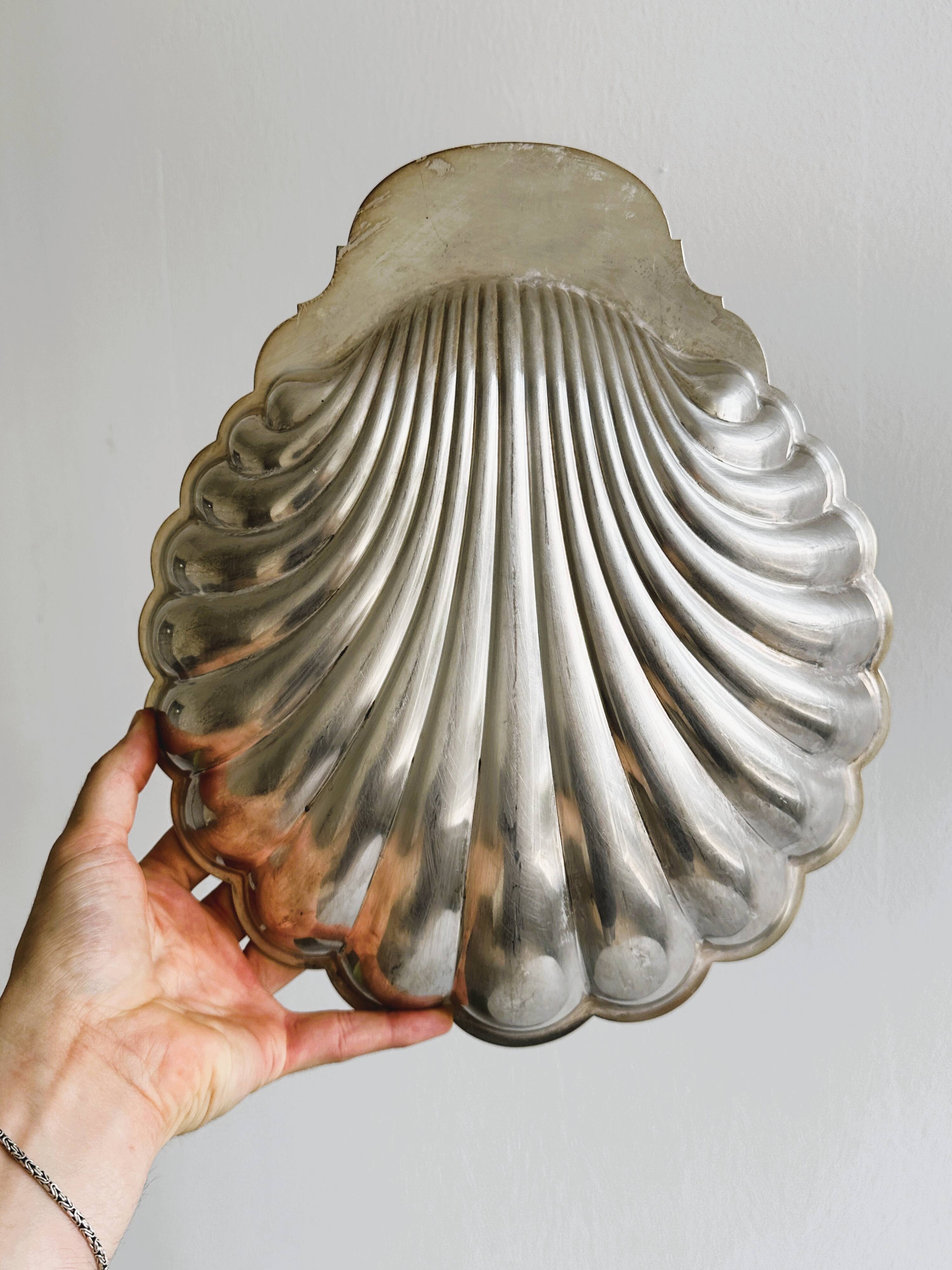 large silver-plated metal shell-shaped dish