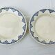 Pair of flat cut on foot faience white and blue