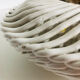 Covered basket in white woven ceramic and fruit slip.