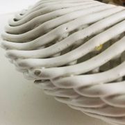 Covered basket in white woven ceramic and fruit slip.