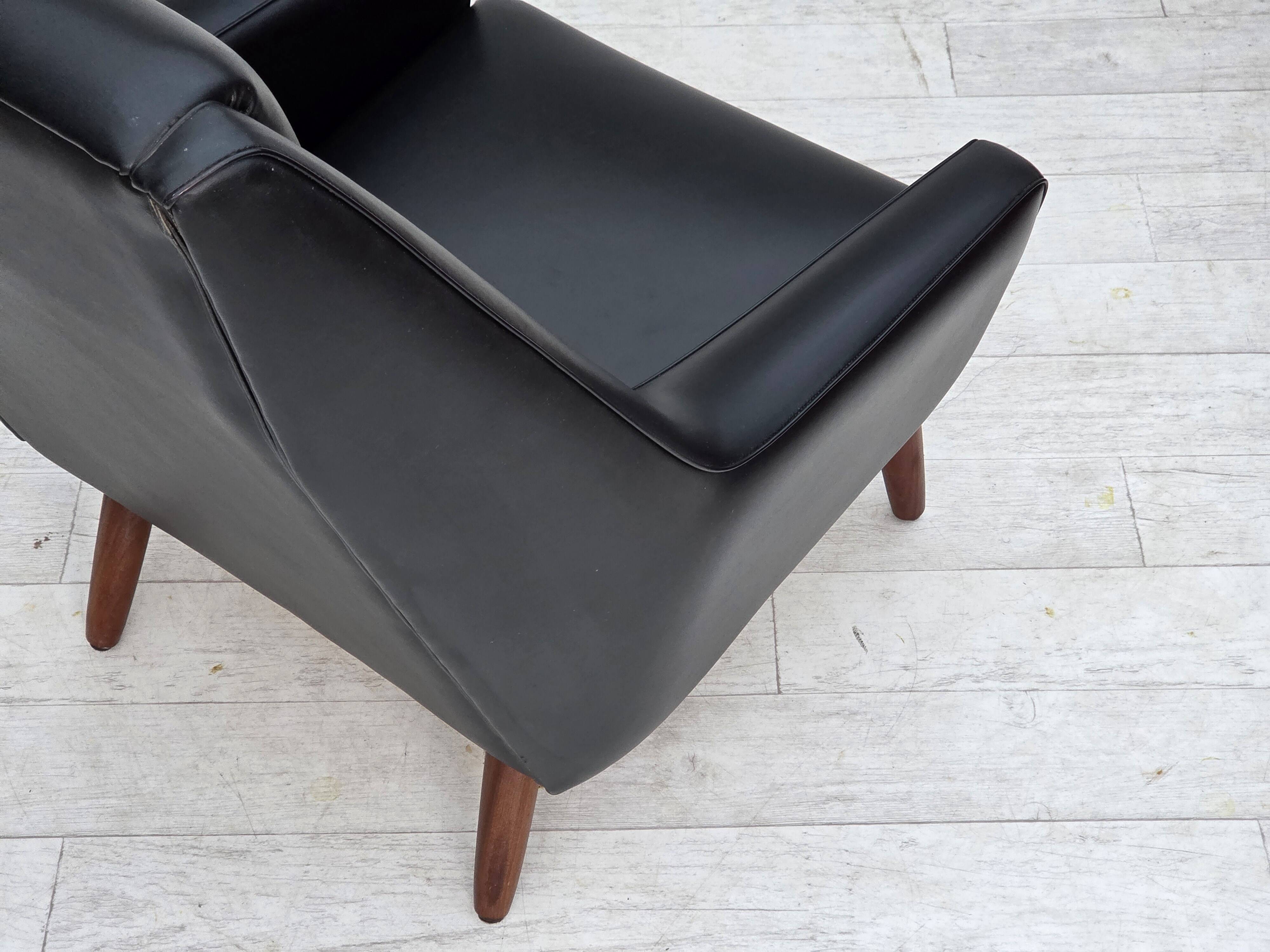 1970s, Danish highback armchair, black artificial leather, teak wood legs.