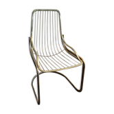 Tubular metal chair covered with gilding