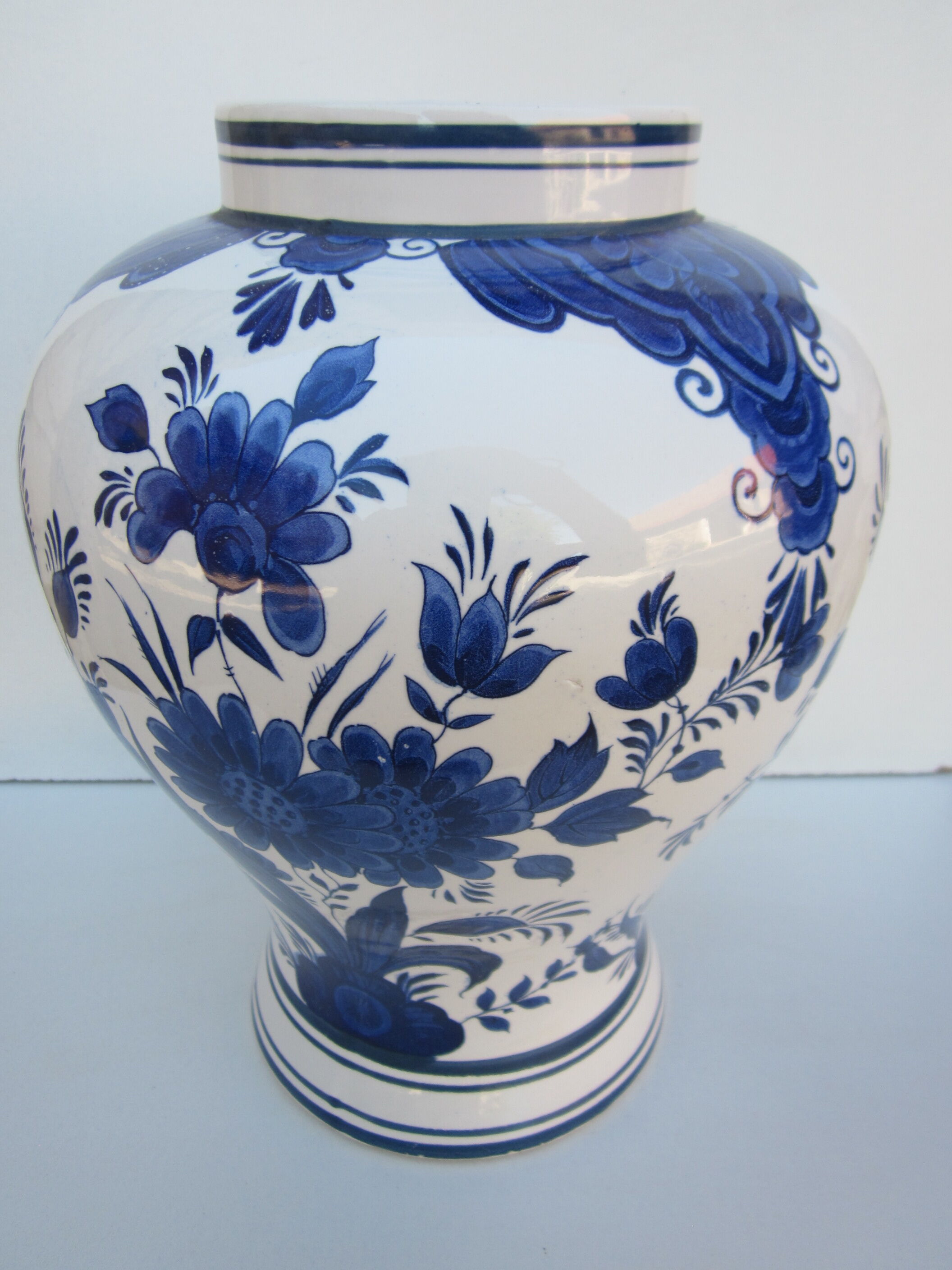 Ceramic vase earthenware, blue floral decoration on a white background