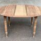 Renovated 18th century solid wood extendable round dining table with shutters
