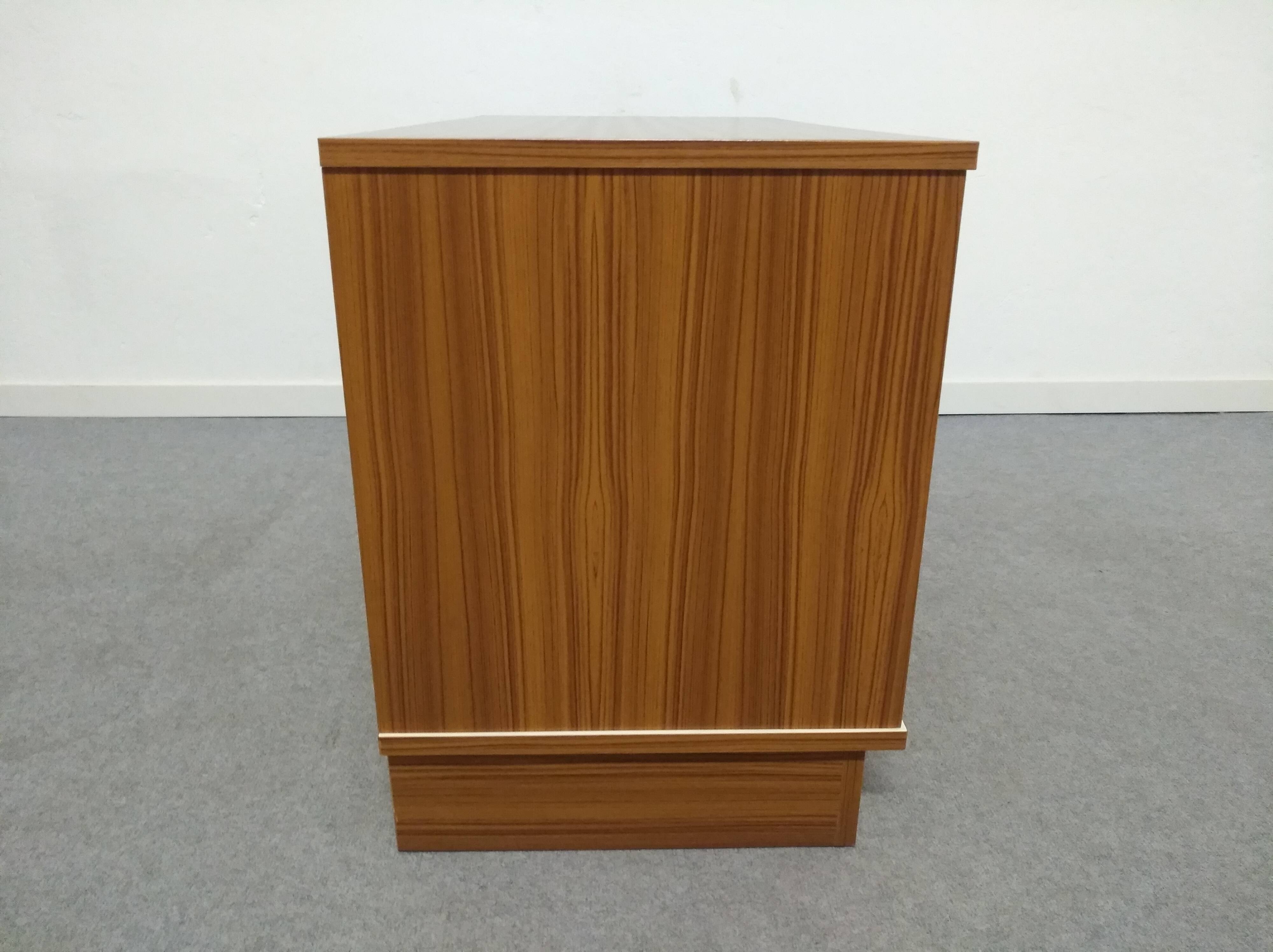 Low chest of drawers with 3 drawers in mahogany and white satin, France circa 1980.