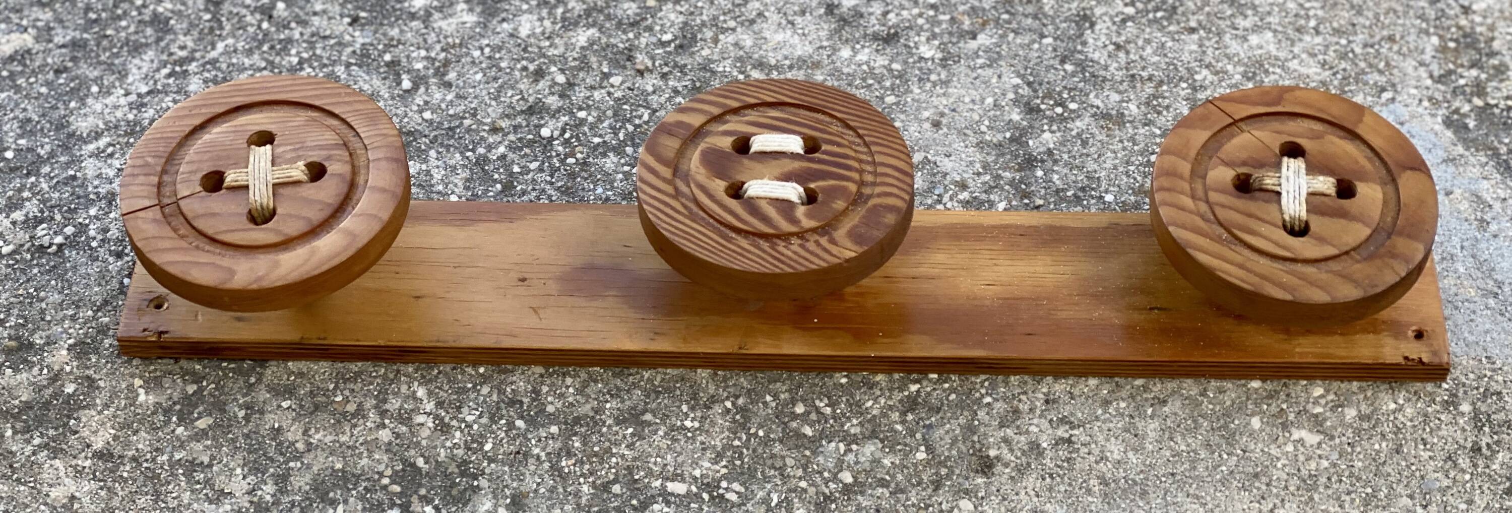 Vintage 1980 coat rack with 3 "button" hooks.