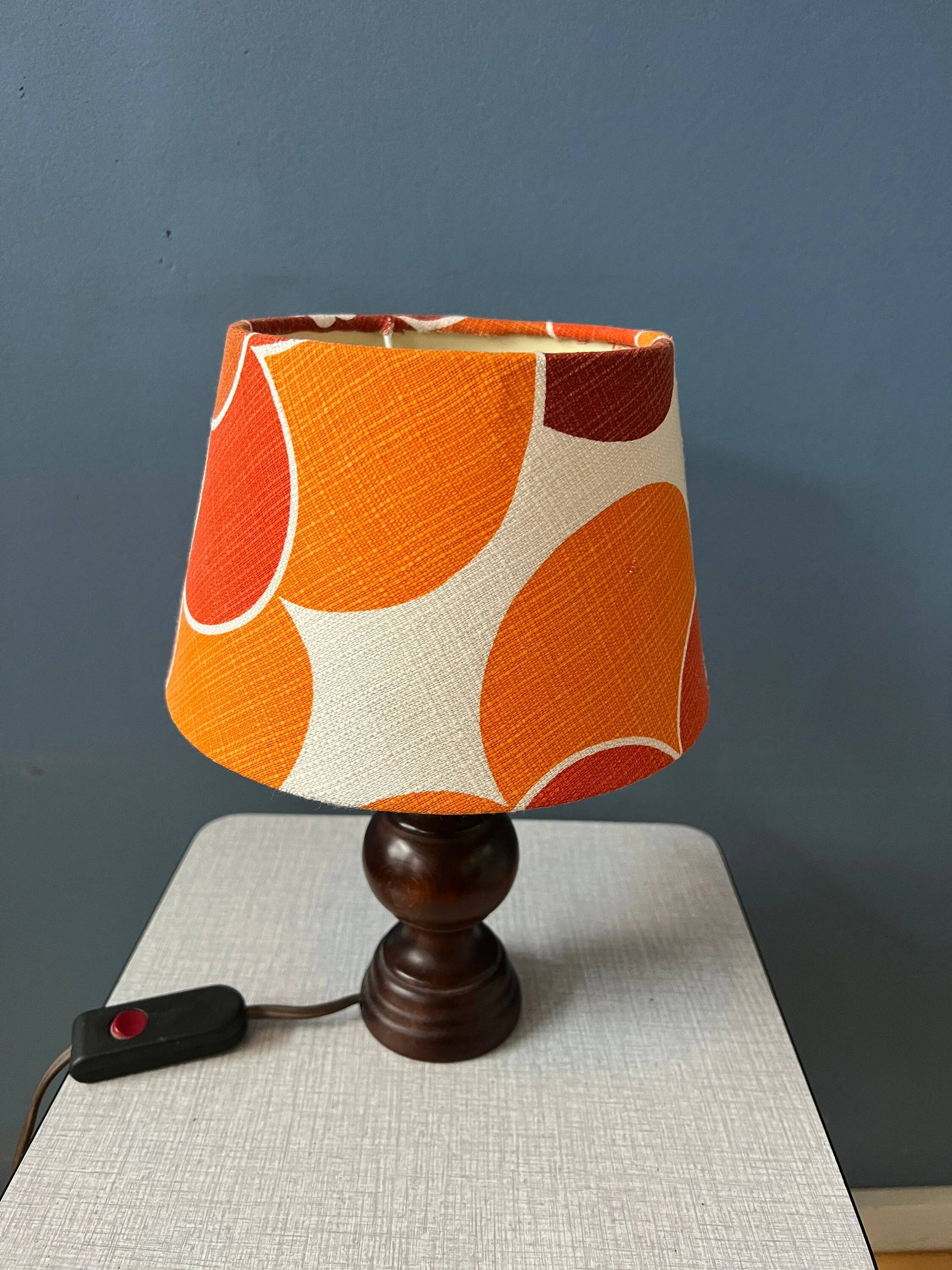 Vintage Space Age table lamp with orange fabric shade.