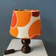 Vintage Space Age table lamp with orange fabric shade.