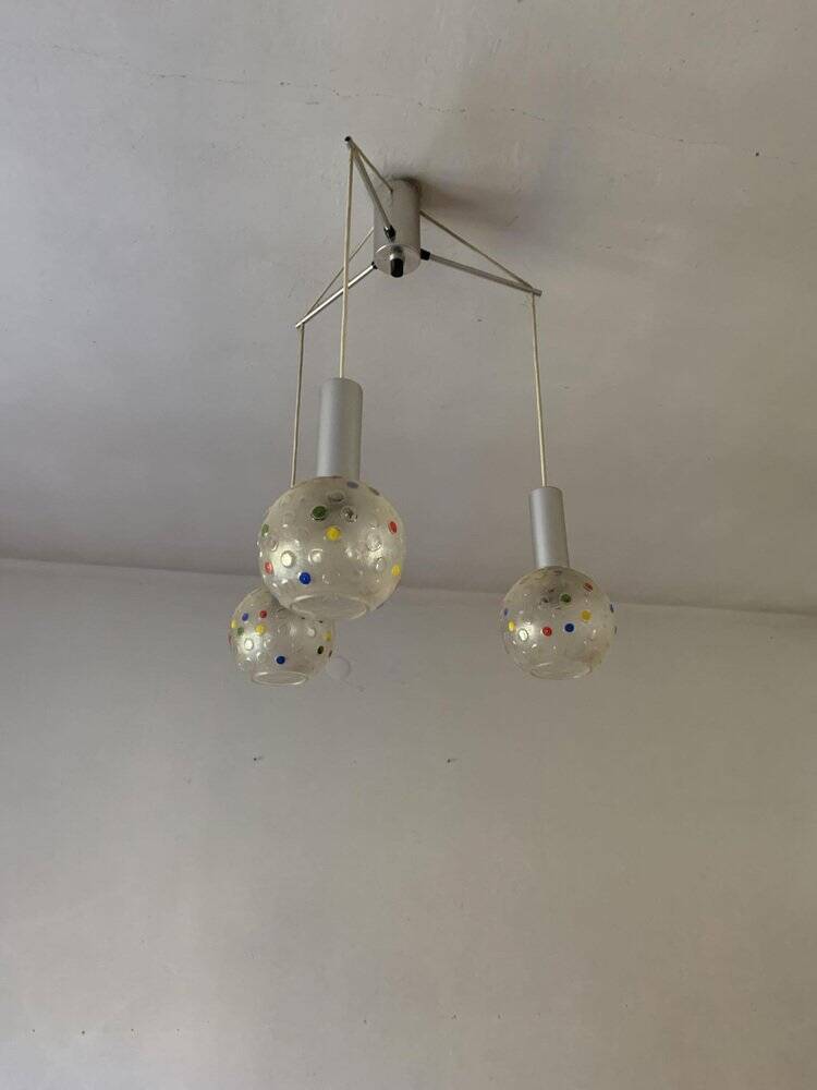 Vintage multicoloured glass sphere ceiling light with red dots and metal structure.