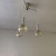 Vintage multicoloured glass sphere ceiling light with red dots and metal structure.
