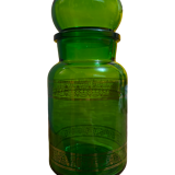 Green apothecary jar with golden patterns