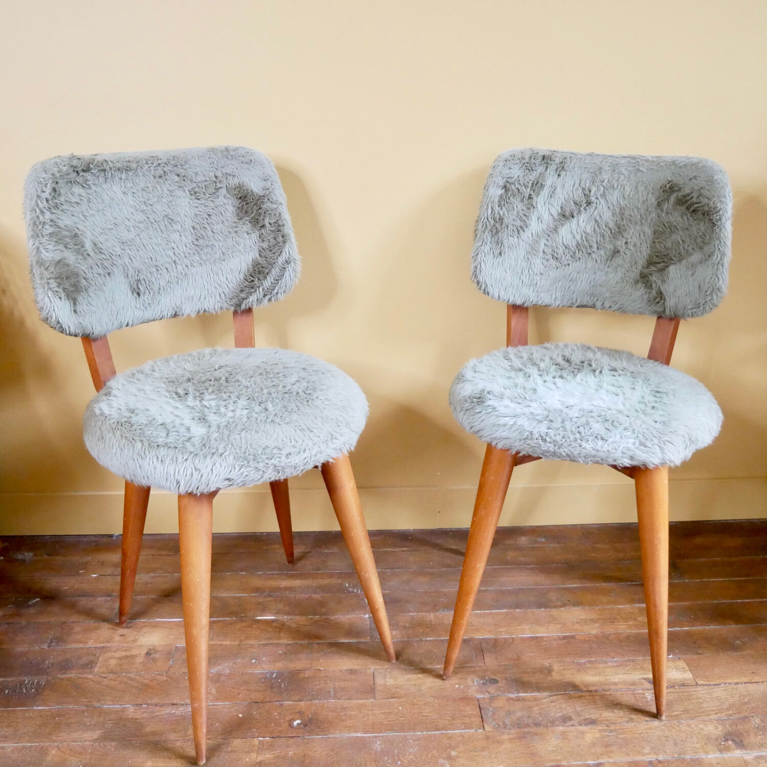 Pair of moumoute chairs with compass feet