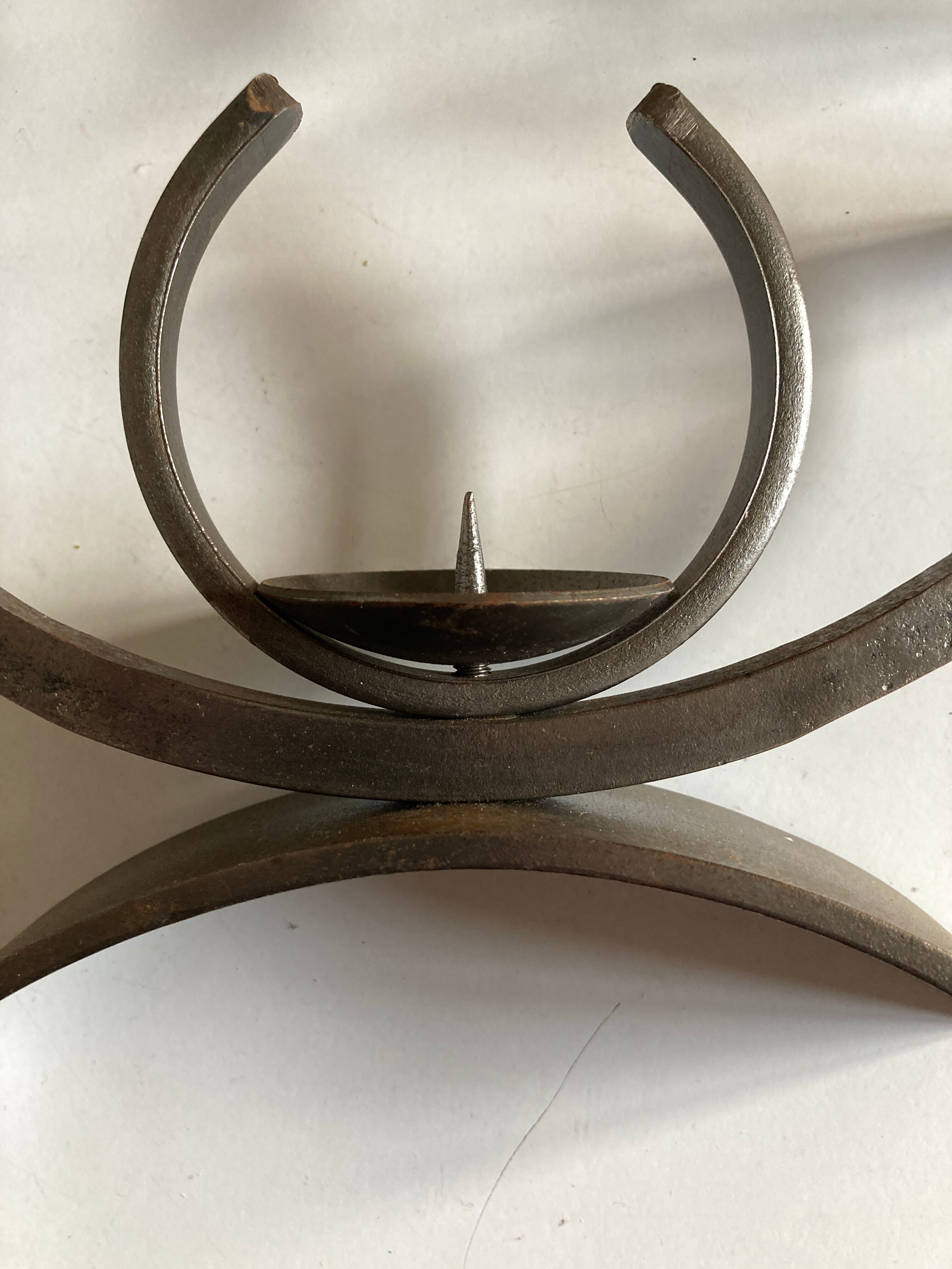 Pair of modernist candlesticks in beaten iron 1970