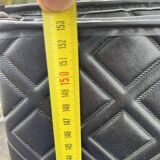 Contemporary wardrobe in black faux leather with diamond pattern and gold handles.