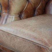 Chesterfield armchair in English style made of cowhide leather