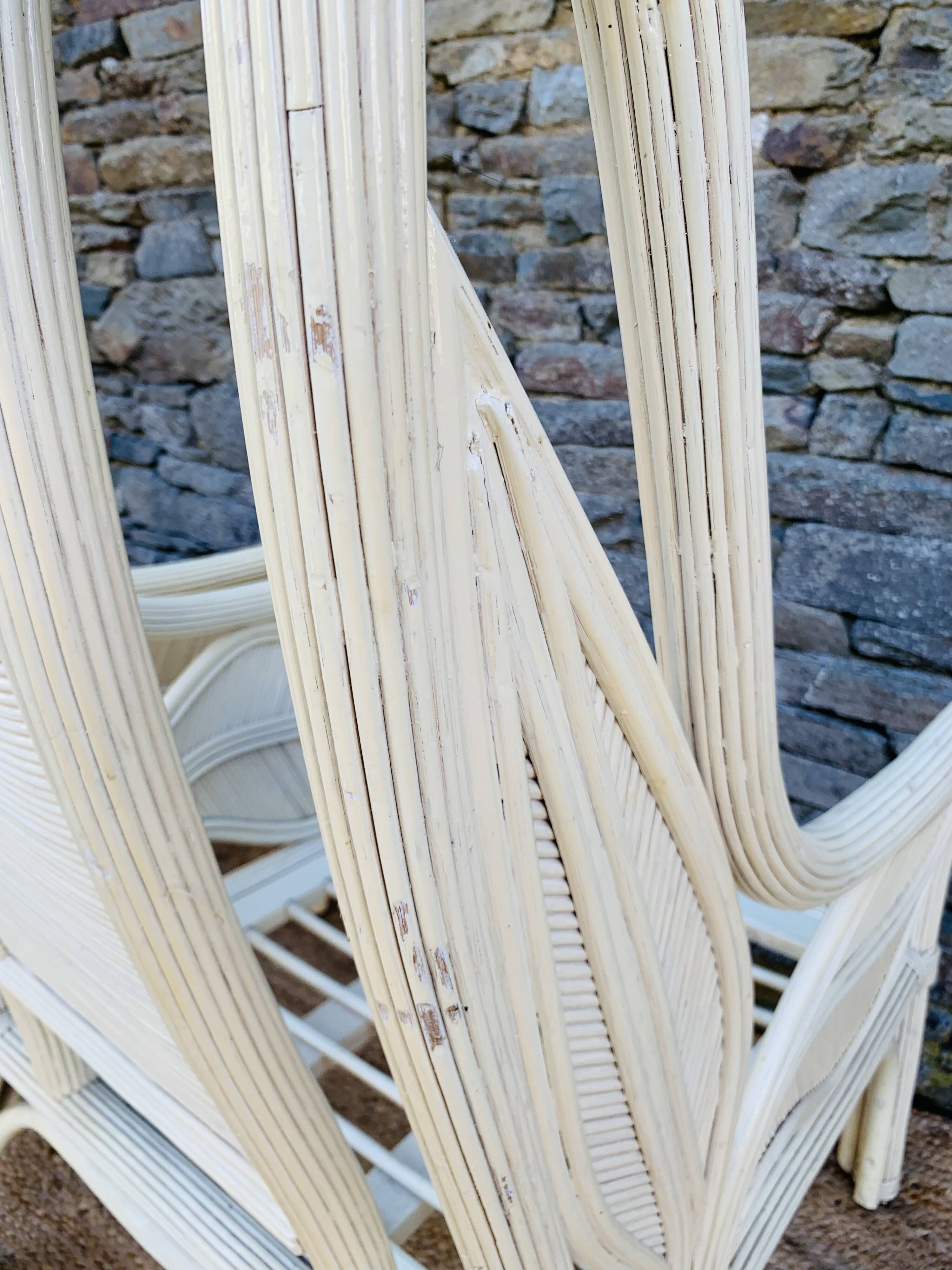 Pair of white rattan armchairs