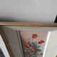 Pair of framed paintings featuring a composition of flowers.