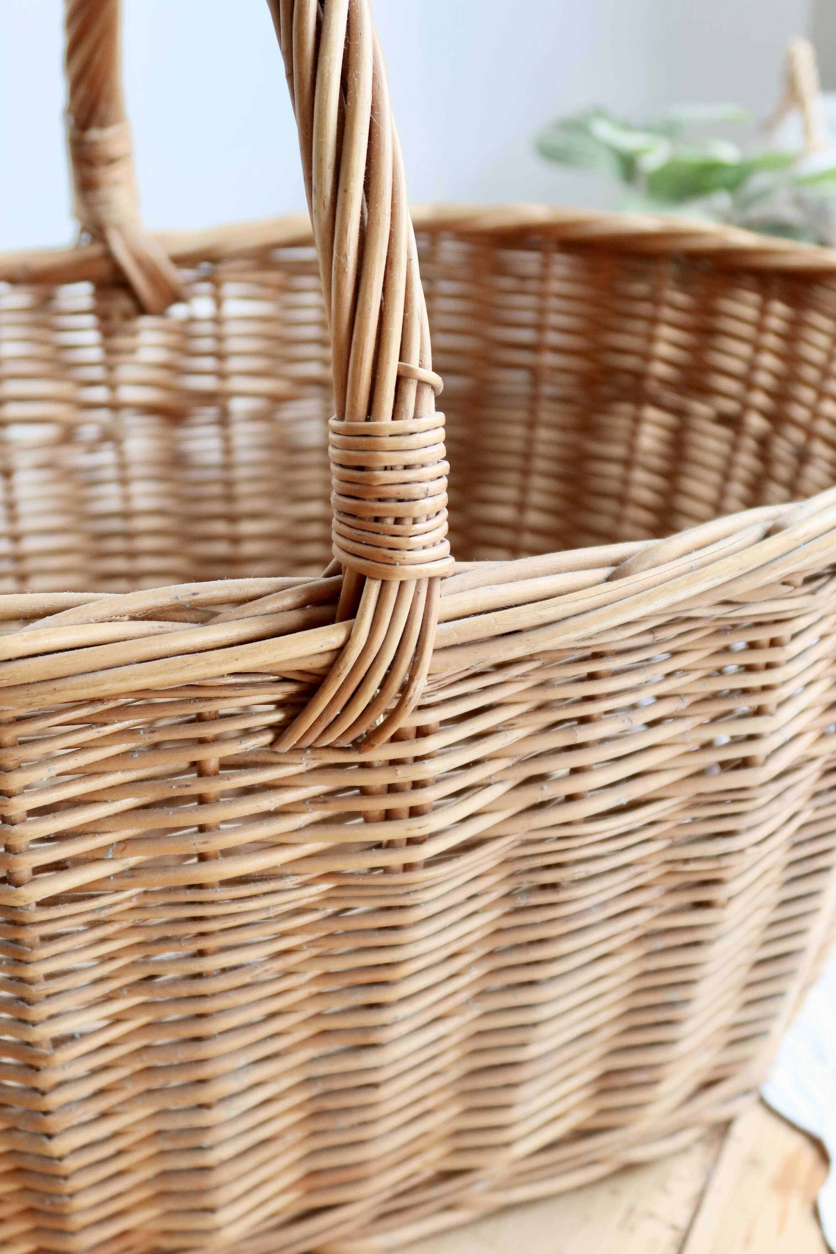 Large vintage woven wicker basket with a central handle.