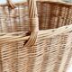 Large vintage woven wicker basket with a central handle.