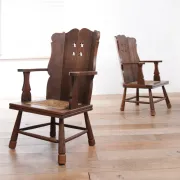 Pair of brutalist oak lounge chairs with rush seats, circa 1935
