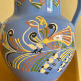 Glazed blue ceramic vase with folk decoration