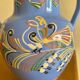 Glazed blue ceramic vase with folk decoration