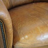 Sheep leather club chair in a cognac color with patina