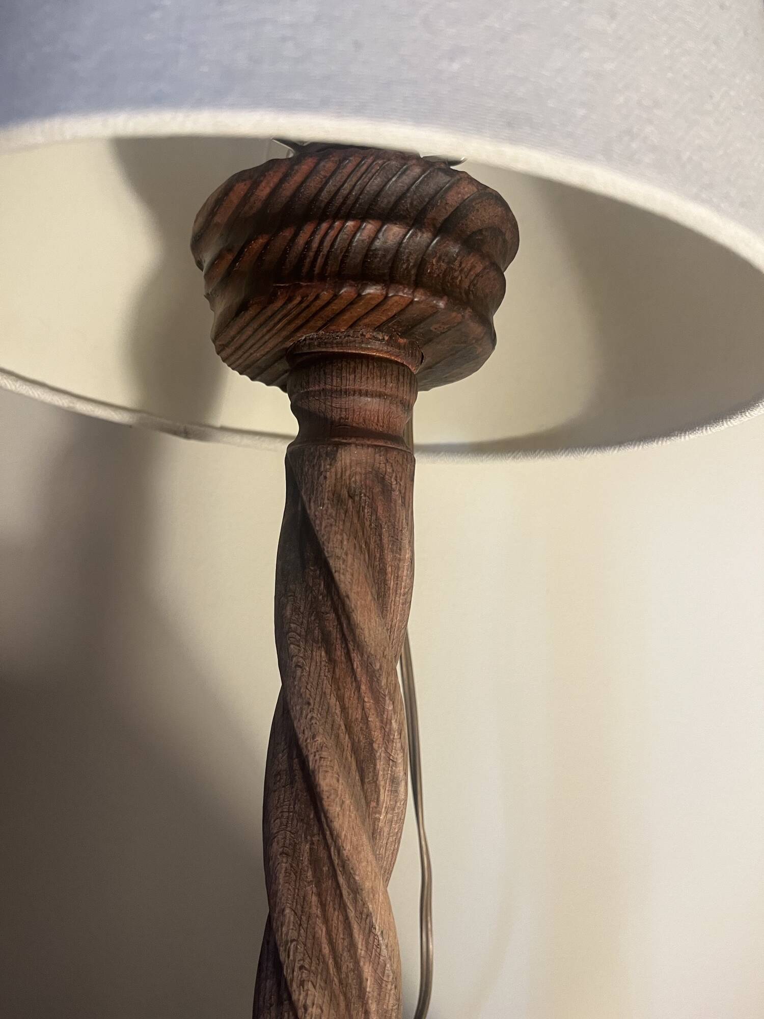 Wooden floor lamp with white tweed shade.