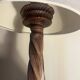 Wooden floor lamp with white tweed shade.