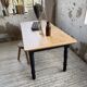 Oak farmhouse table with turned black legs.