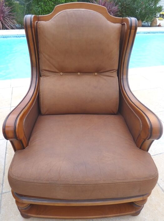 Pair of aged leather armchairs with seat and firm backrest with cherry wood frame