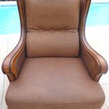 Pair of aged leather armchairs with seat and firm backrest with cherry wood frame