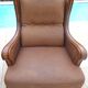 Pair of aged leather armchairs with seat and firm backrest with cherry wood frame
