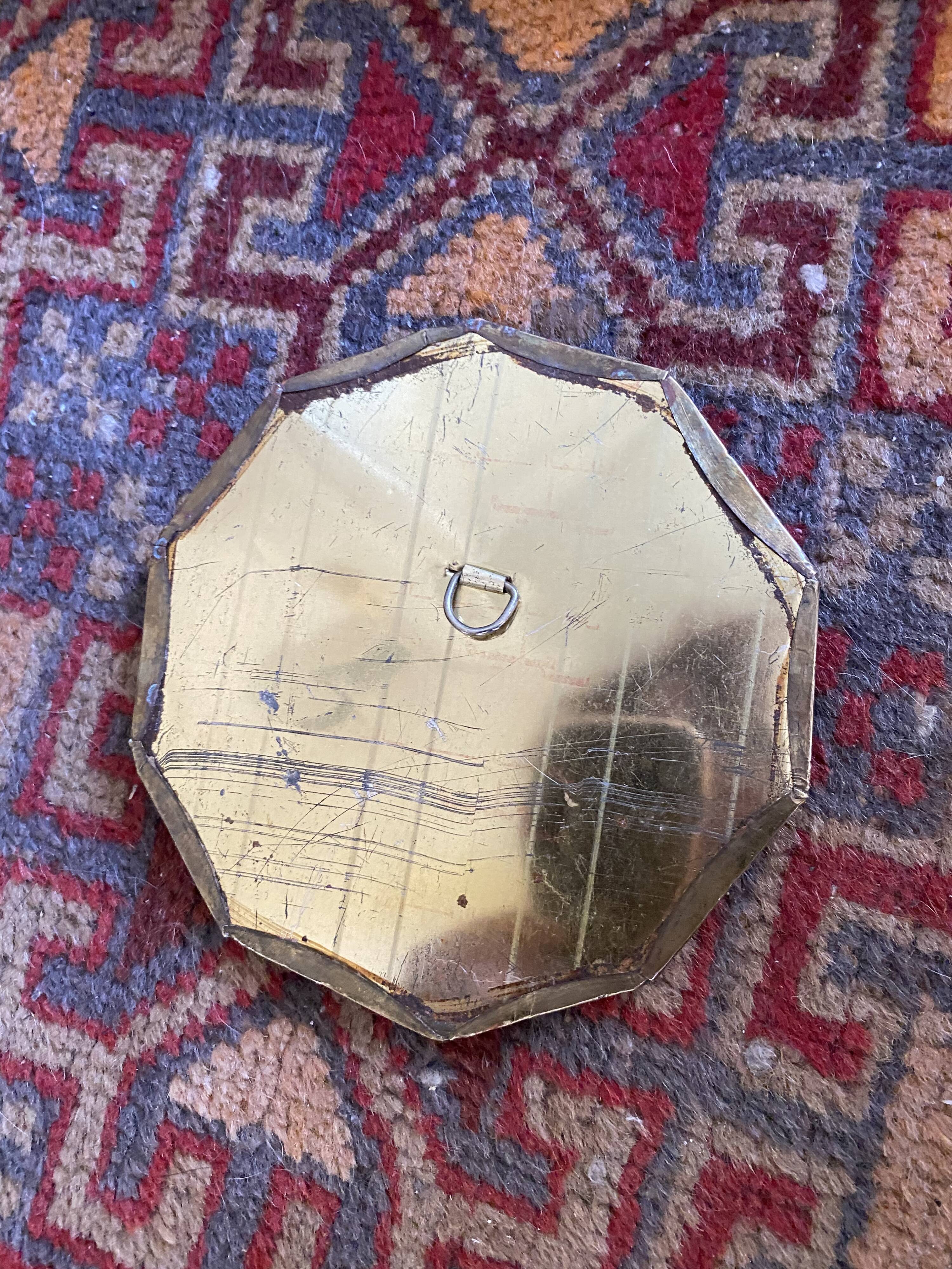 Antique mirror in worked brass