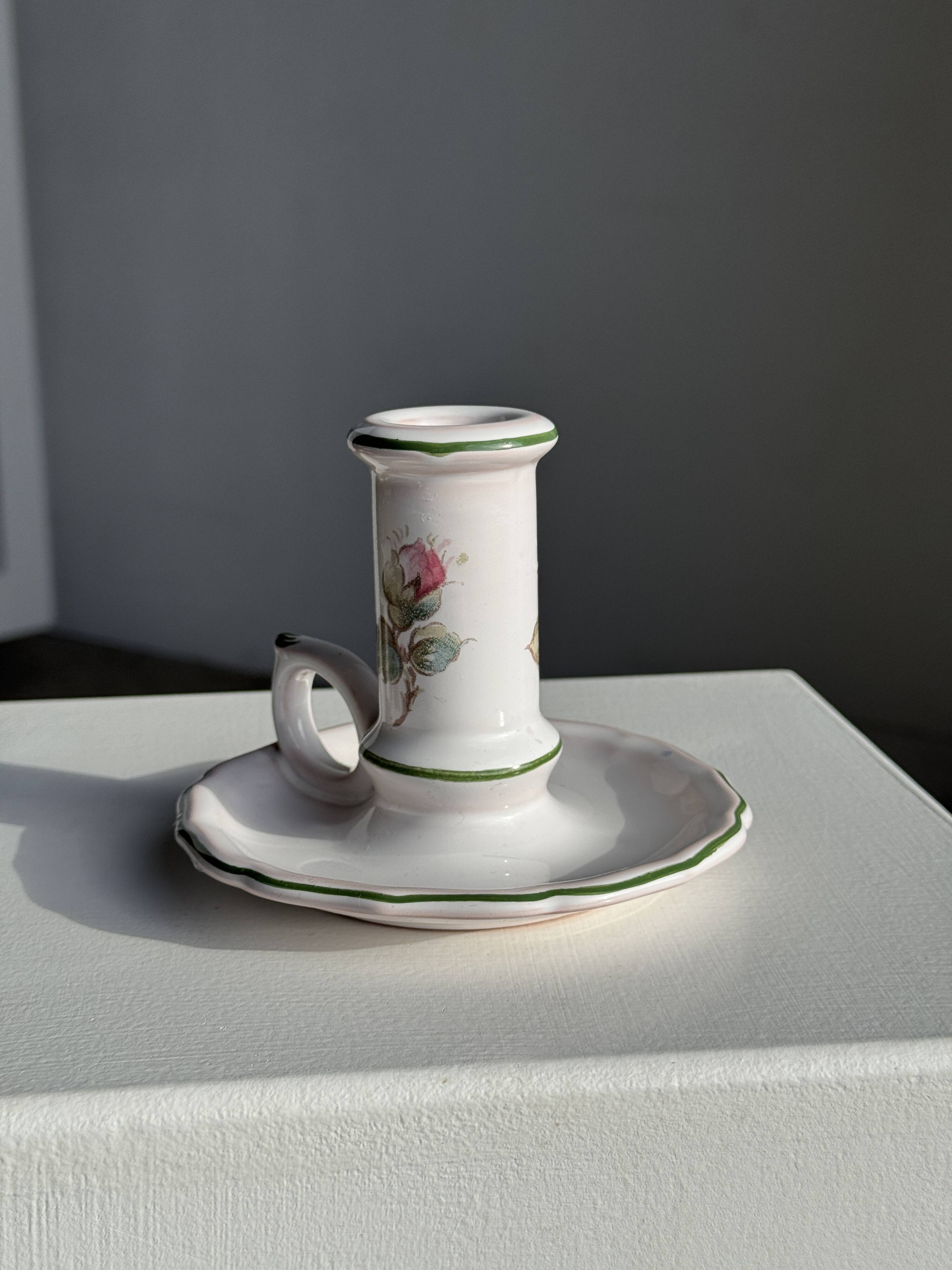 Small vintage hand-held candlestick in earthenware with green trim and floral decoration H10.5