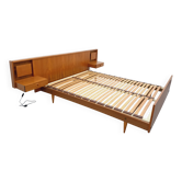 Double bed in vintage Scandinavian style from the 1960s with bedside tables in teak.