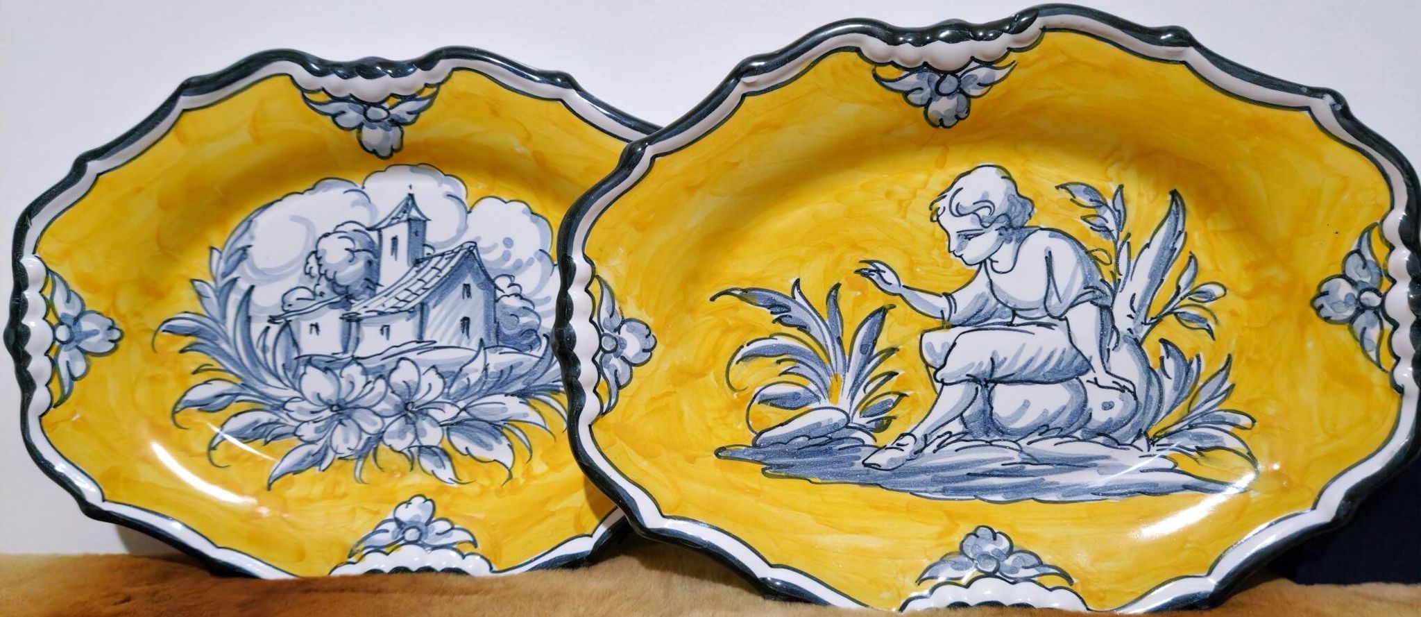 Pair of oval dishes in hand-painted faience with an Italian majolica spirit.